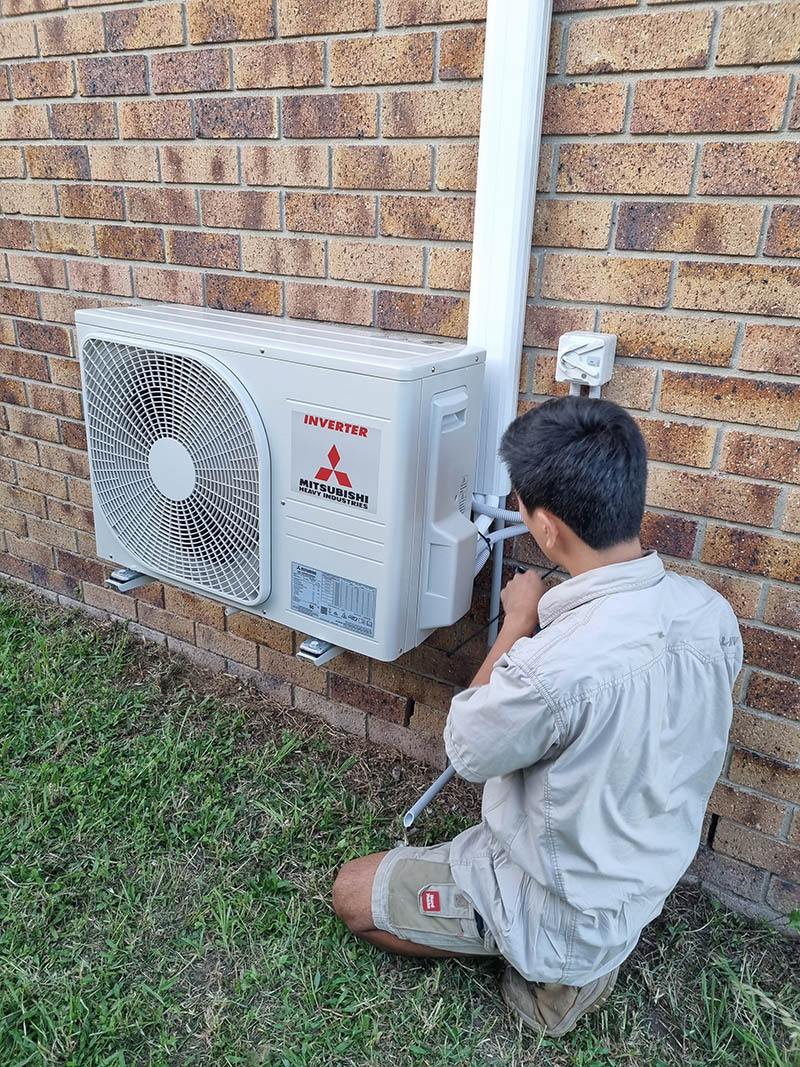 Swind technician servicing a residential air conditioner